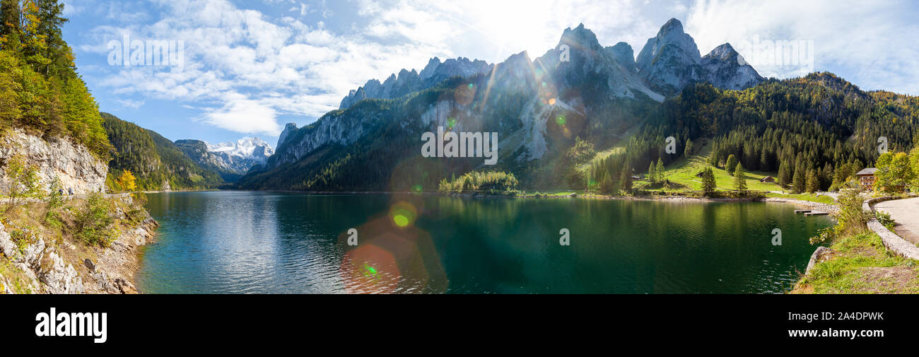 Famous Lake Gosau and Gosaukamm with Mount Dachstein. The sun is about to hide behind the high peaks while autumn is about to settle in with all the v Stock Photo