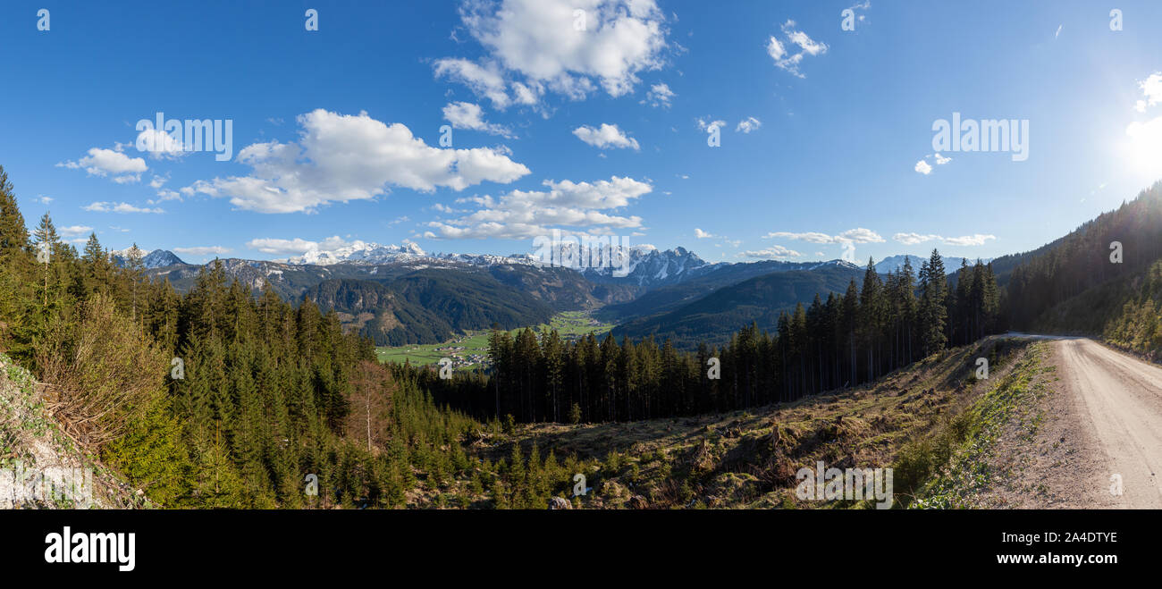 Mount Dachstein, the famous Gosaukamm and the village Gosau in Gosauvalley on a sunny spring day. The last bits of snow are still covering the mountai Stock Photo