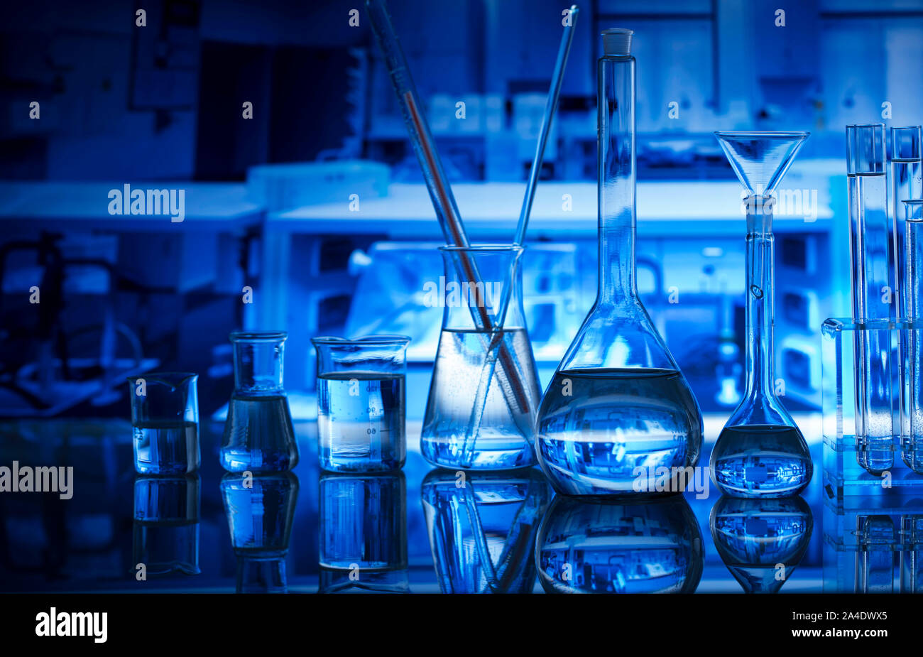 Science laboratory concept background. Microscope and laboratory glassware composition. Stock Photo