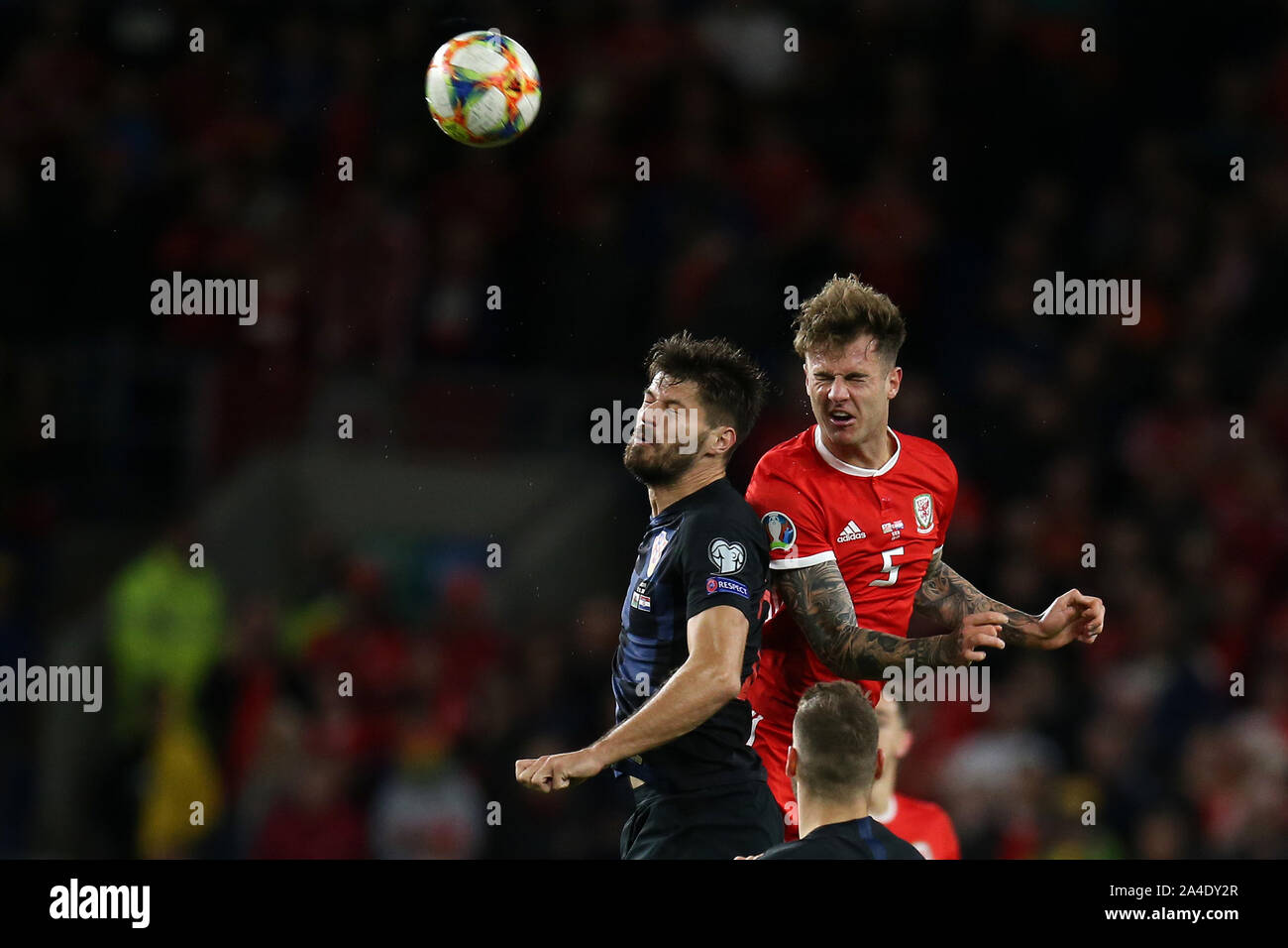Cardiff, UK. 13th Oct, 2019. Joe Rodon of Wales jumps for a header with Bruno Petkovic of Croatia (l).UEFA Euro 2020 qualifier match, Wales v Croatia at the Cardiff city Stadium in Cardiff, South Wales on Sunday 13th October 2019. pic by Andrew Orchard /Andrew Orchard sports photography/Alamy live News EDITORIAL USE ONLY Credit: Andrew Orchard sports photography/Alamy Live News Stock Photo
