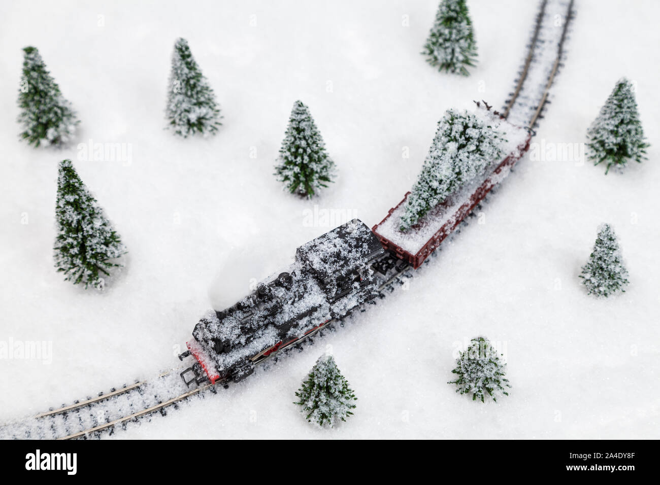 Christmas train with christmas tree freight in snowy landscape Stock Photo