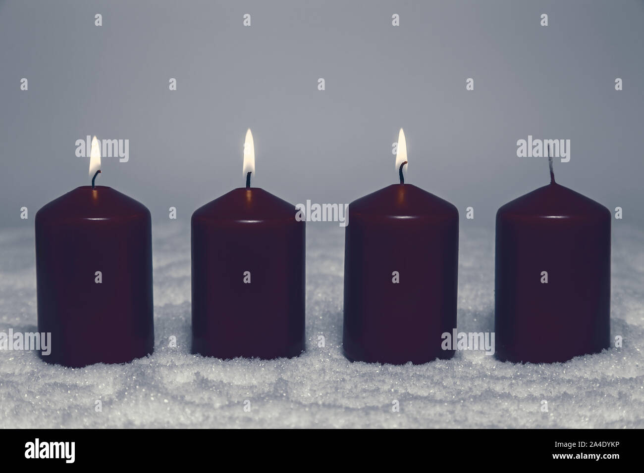 3rd advent with three burning candles in snow Stock Photo
