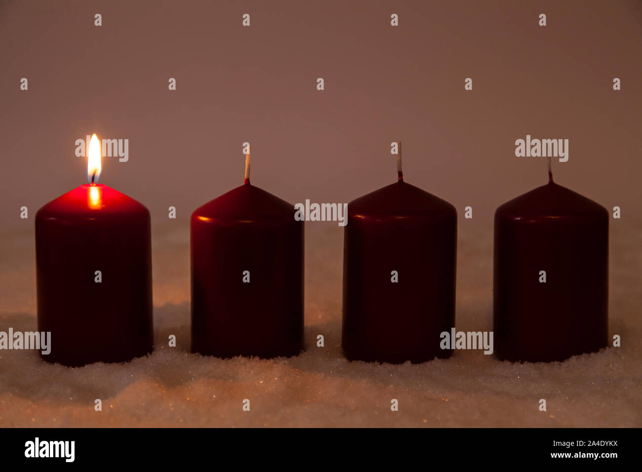 First Advent with one burning candle in snow Stock Photo