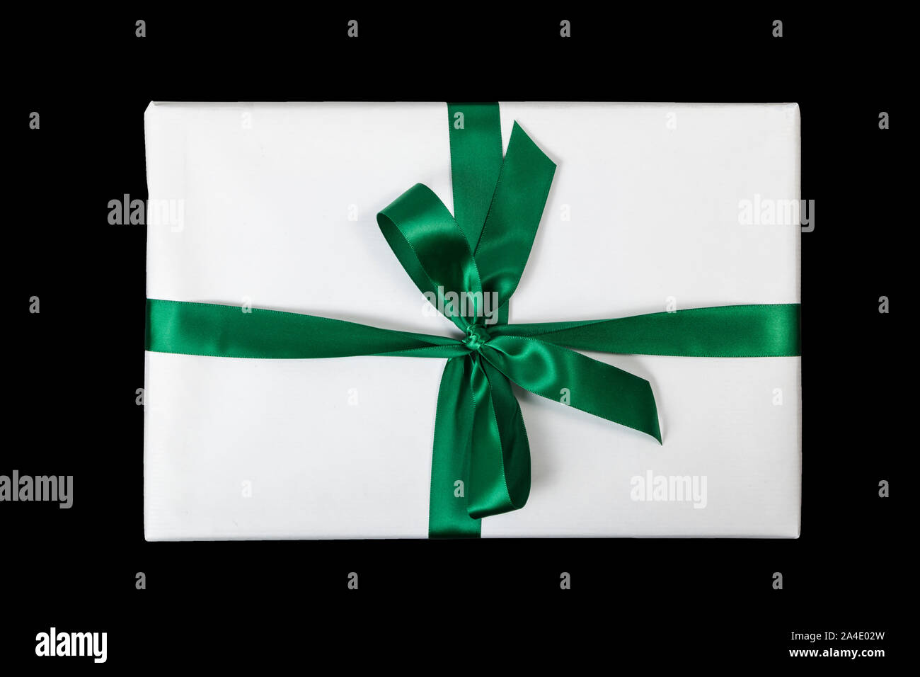 White christmas present with green ribbon on black background (top view) Stock Photo