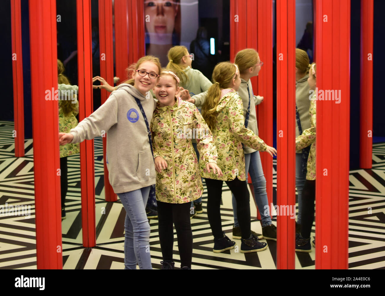 Two girls in a mirror maze. Stock Photo