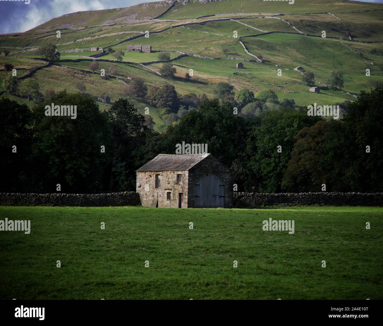 Chasing the sun shadows, stone field barn, Swaledale, Yorkshire Dales Stock Photo