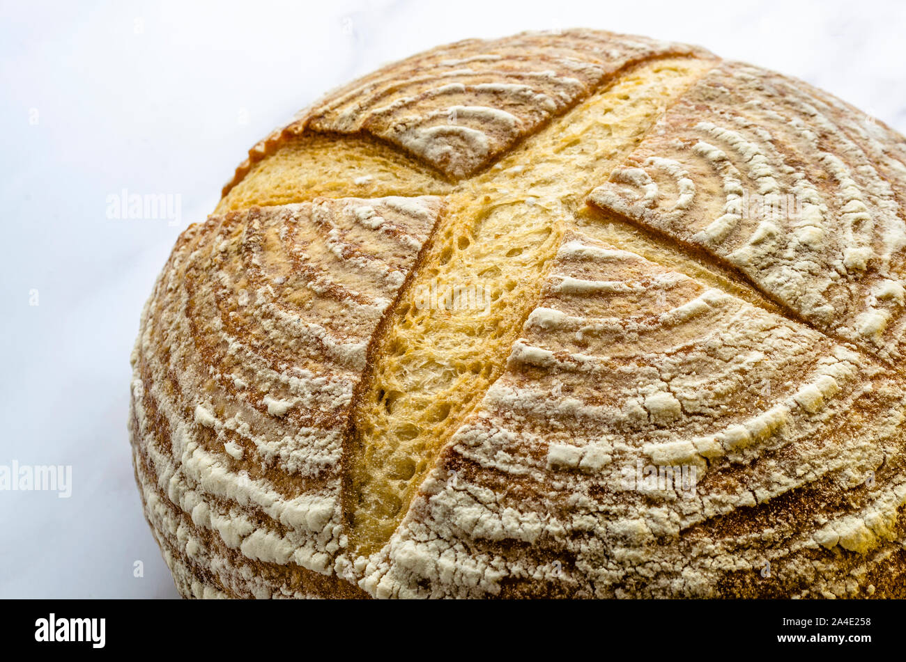 A close up of a freshly baked sourdough bread showing the traditional