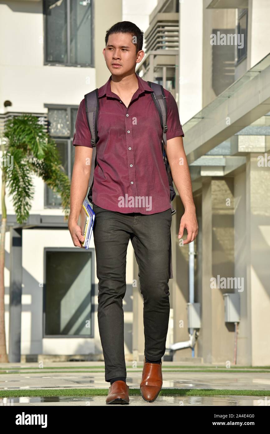Unemotional Asian Boy Student Walking On Campus Stock Photo - Alamy