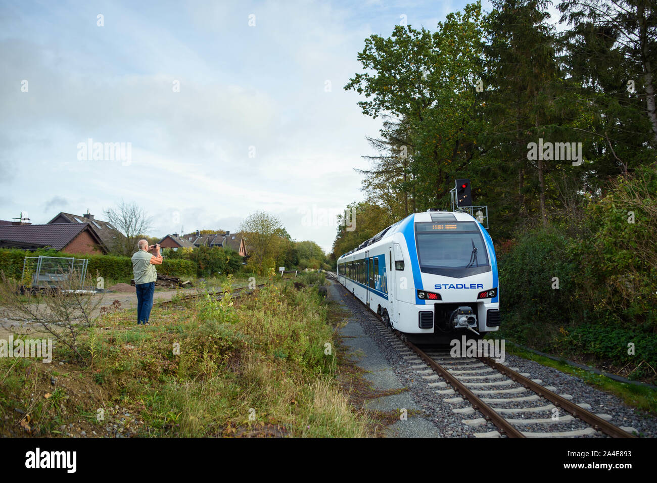 Oppendorf, Germany. 14th Oct, 2019. A local resident films a 'FLIRT Akku' test train during a transit at the station of the village Oppendorf of the municipality Schönkirchen. Stadler and the Schleswig-Holstein public transport association have signed a supply contract for 55 battery-powered railcars. The first battery multiple units are to be deployed in the northern and eastern networks of Schleswig-Holstein at the end of 2022. Credit: Gregor Fischer/dpa/Alamy Live News Stock Photo
