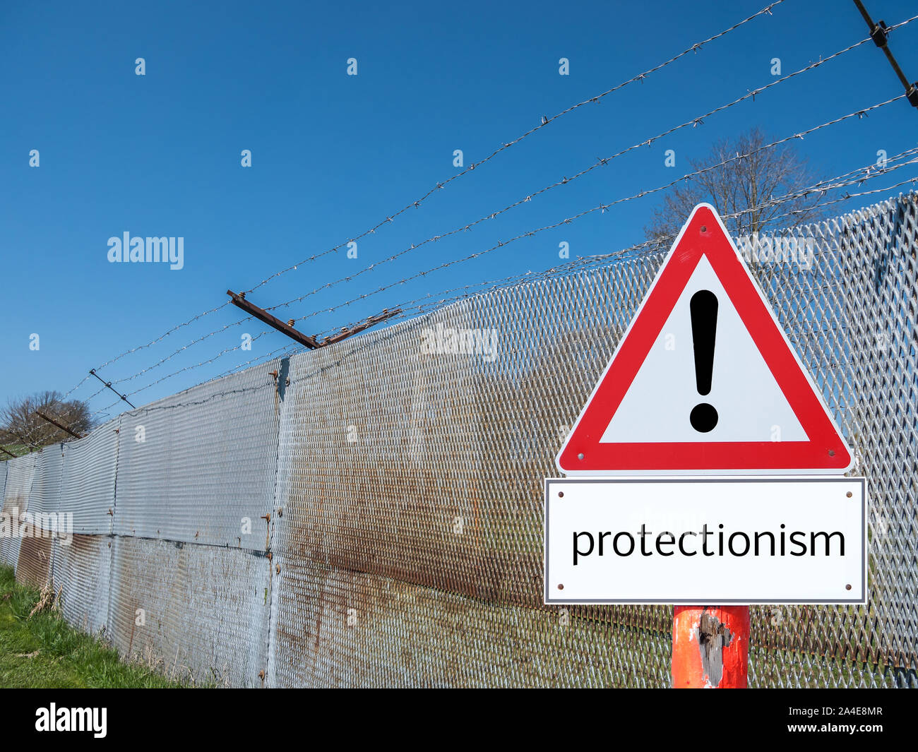 Border fence with warning sign protectionism Stock Photo