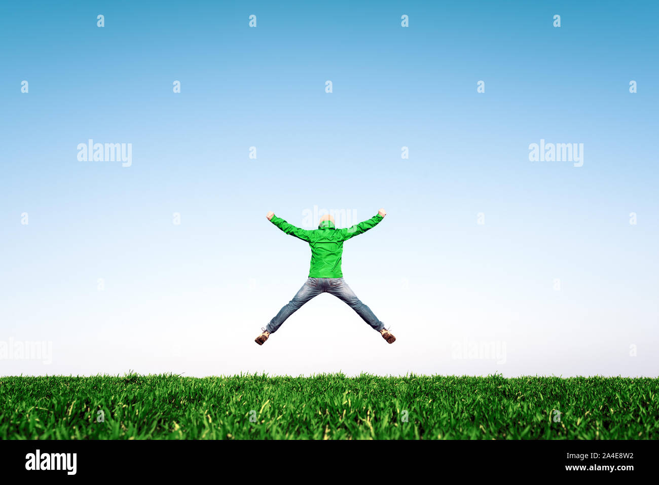 Man jump on amazing meadow in summer field. Success and happiness concept Stock Photo