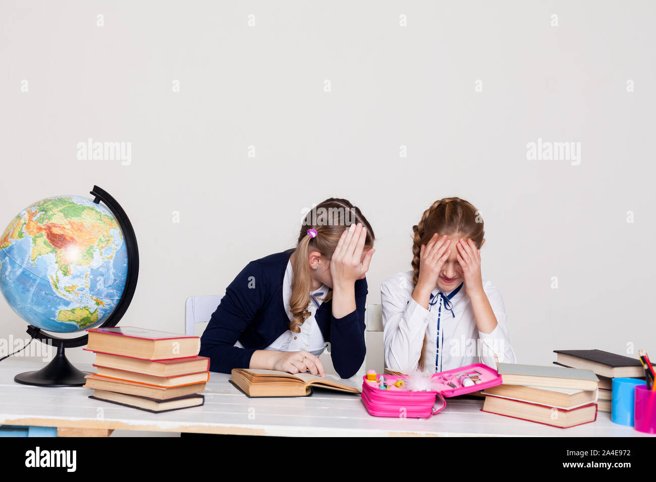 two schoolgirl girls at the desk in a geography class Stock Photo - Alamy