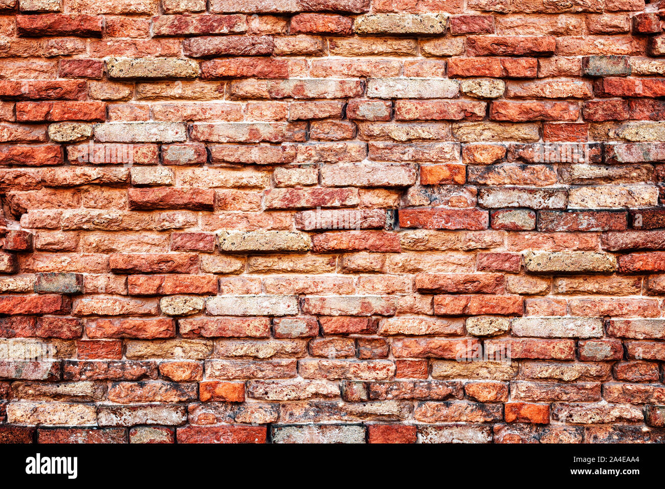 Old orange brick wall background with aging and rustic texture Stock Photo