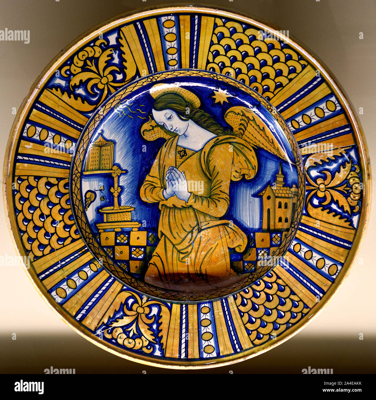 The Angel of the Annunciation from Deruta (first third  16th century)  Dish Glossy earthenware D. 42 cm. (Deruta, a medieval hill town in Umbria,) Italy, Italian.Annunciation, blessed, Virgin Mary, the announcement by the ,angel Gabriel, Mary that she would conceive, bear a son through a, virgin birth, become the, mother of Jesus Christ, Christian Messiah and Son of God, Incarnation, Stock Photo