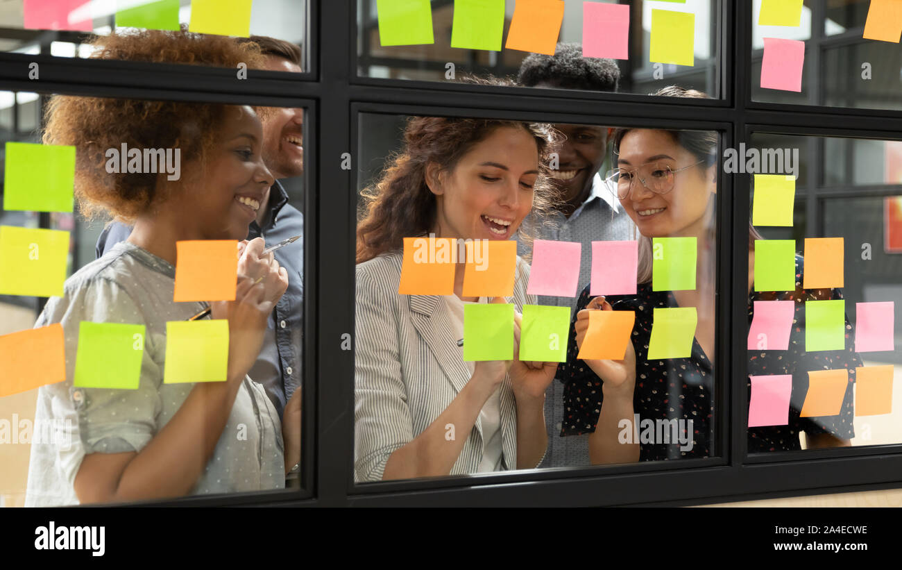 Businesspeople working on new project writing ideas using sticky notes Stock Photo
