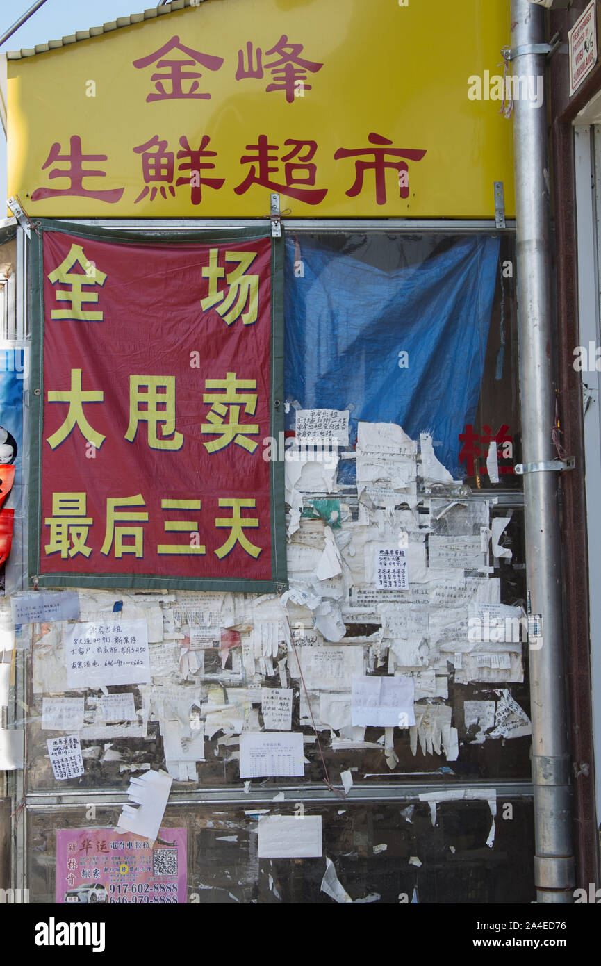 Public bulletin board outside a food market in the Chinatown section of Sunset Park, Brooklyn, NY. Stock Photo