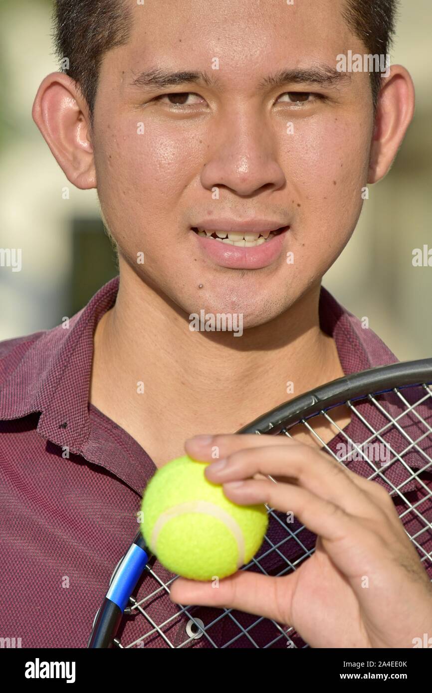 Smiling Athlete Filipino Male Tennis Player With Tennis Racket Stock