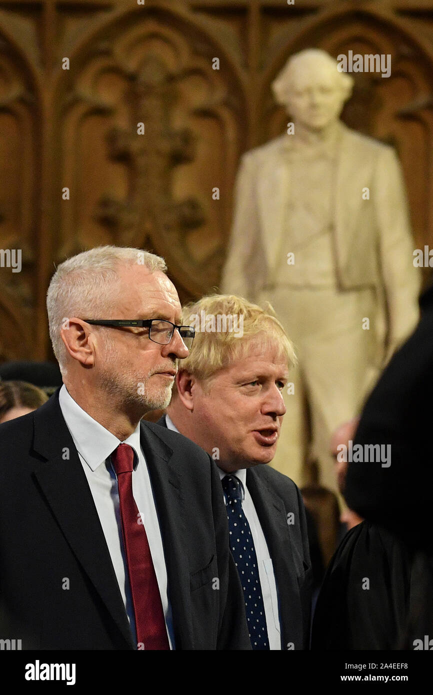 Prime Minister Boris Johnson (right) speaks with Labour Party leader Jeremy Corbyn in the Central Lobby as they walk back to the House of Commons after the Queen's Speech during the State Opening of Parliament ceremony in London. Stock Photo