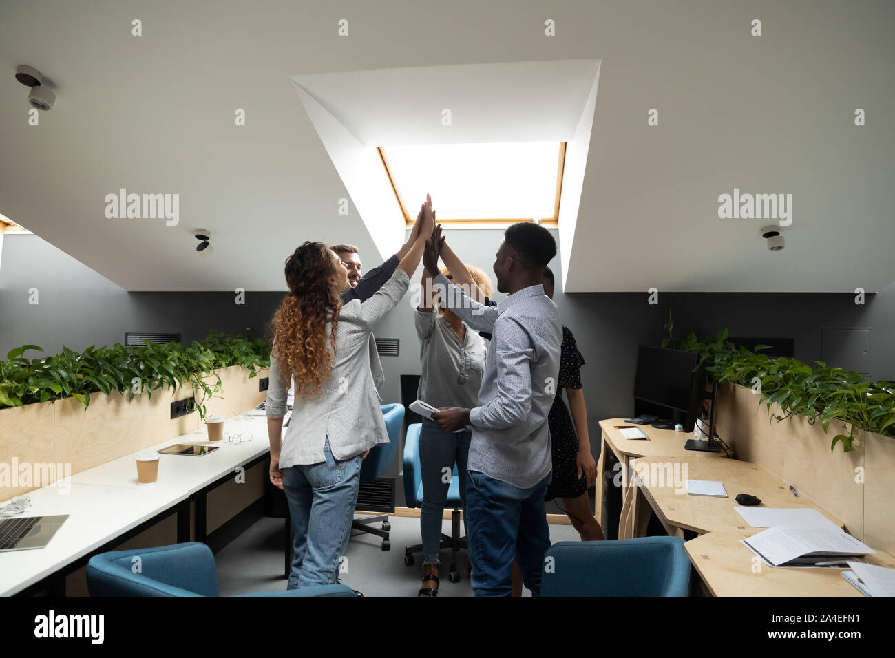 Colleagues giving high five celebrating success at common business ...