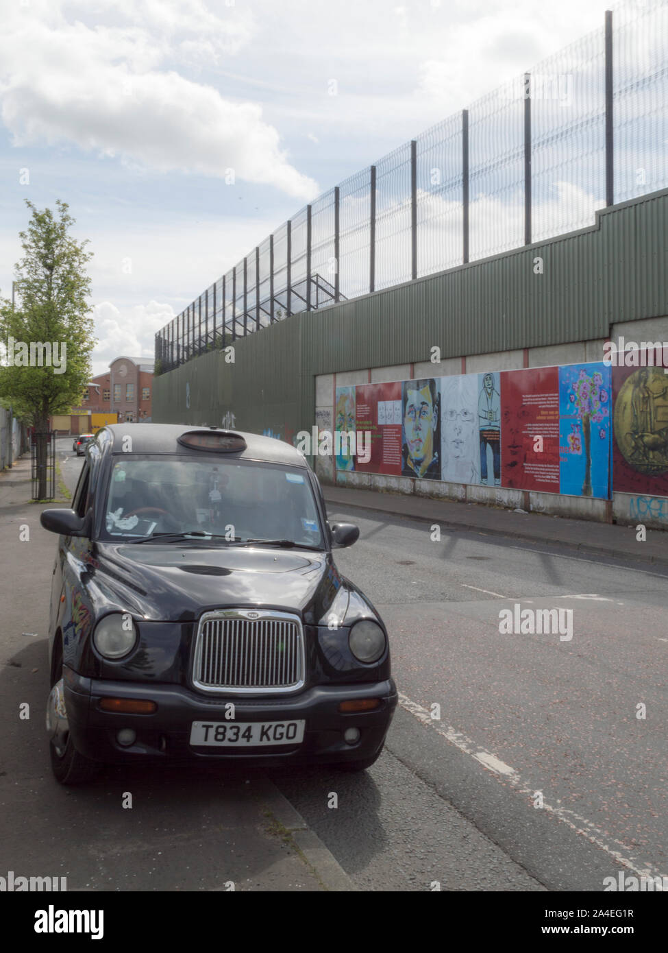 Black cab at The peace line along Cupar Way in Belfast Stock Photo
