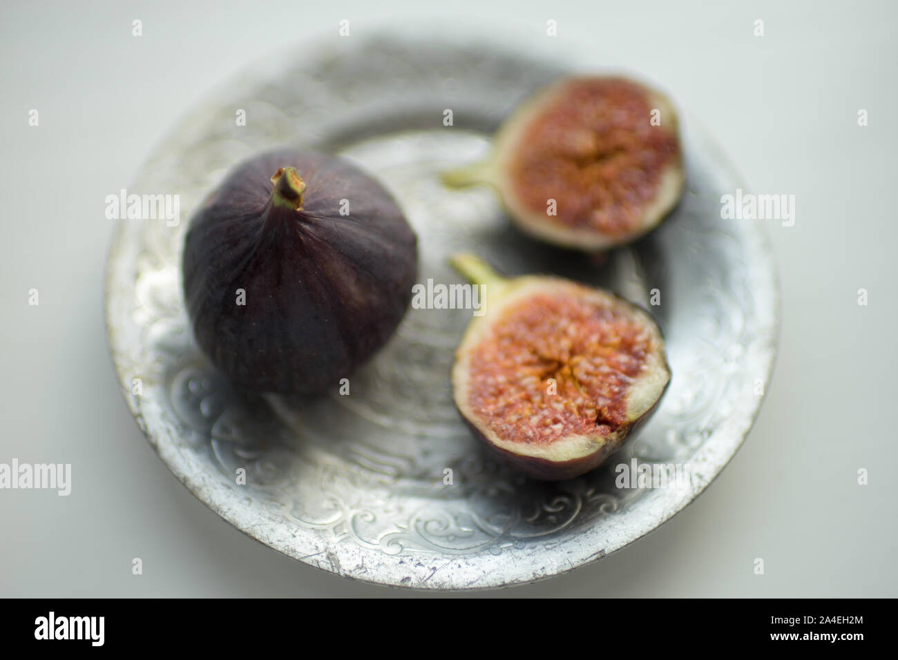 One whole fig and the second cut in half Stock Photo