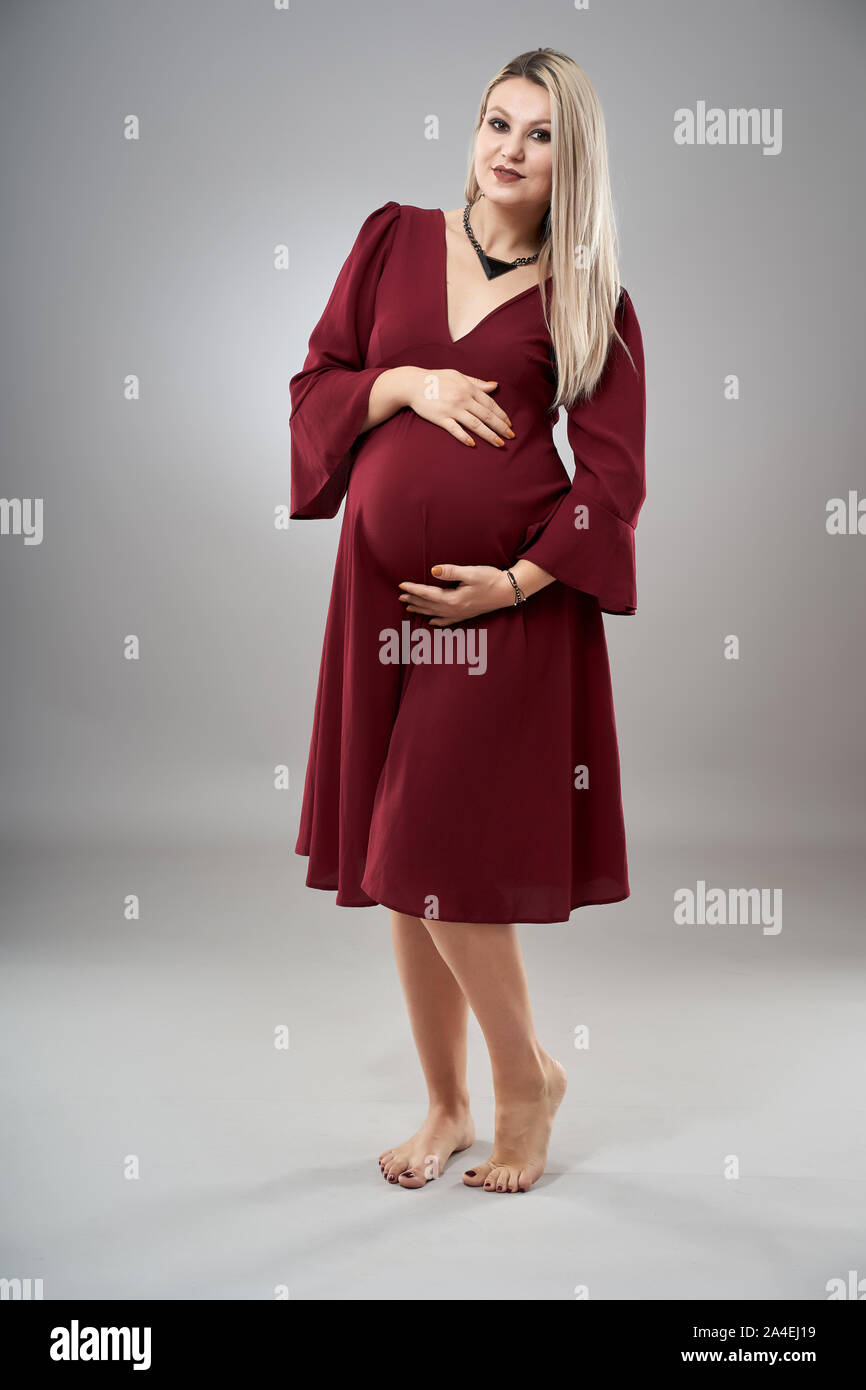 Pregnant woman in red dress hi-res stock photography and images - Alamy