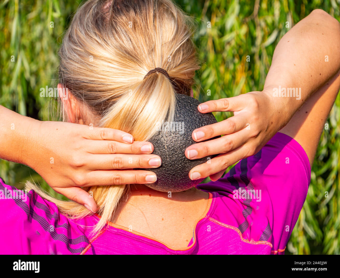 Woman massaging her neck with a fascia ball Stock Photo Alamy