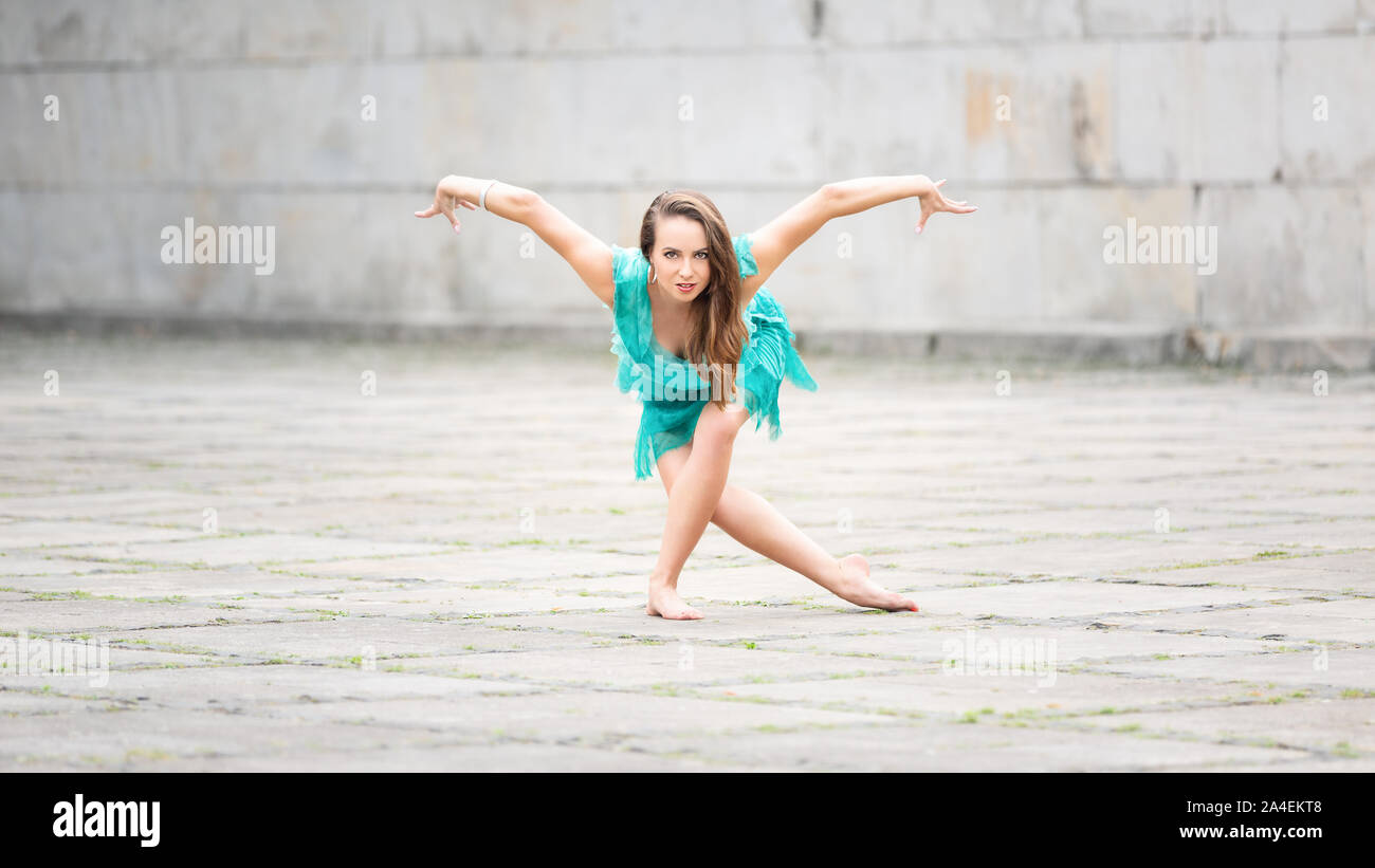 A woman dancing in an empty square Stock Photo