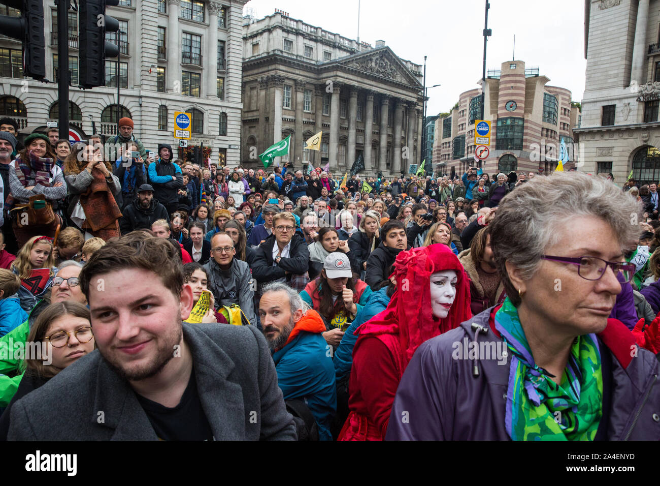 London, UK. 14 October, 2019. Climate activists from Extinction Rebellion watch theatrical mock trials, of the UK’s financial sector for the crime of ecocide and of the Government for ‘criminal negligence’ in having permitted it, in front of the Bank of England. Roads were blocked around Bank on the eighth day of International Rebellion protests across London. Credit: Mark Kerrison/Alamy Live News Stock Photo