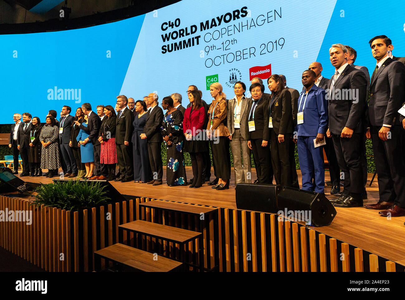 COPENHAGEN, DENMARK – OCTOBER 10. DENMARK: Mayors from the worlds megacities and who has jointed the C40 World Mayors declaration are lined-up for a family photo during the 2019 Summit in Copenhagen.. More than 90 mayors of some of the world’s largest and most influential cities representing some 700 million people meet in Copenhagen from October 9-12 for the C40 World Mayors Summit. The purpose with the Summit in Copenhagen is to build a global coalition of leading cities, businesses and citizens that rallies around radical and ambitious climate action. Also youth leaders from the recent Clim Stock Photo