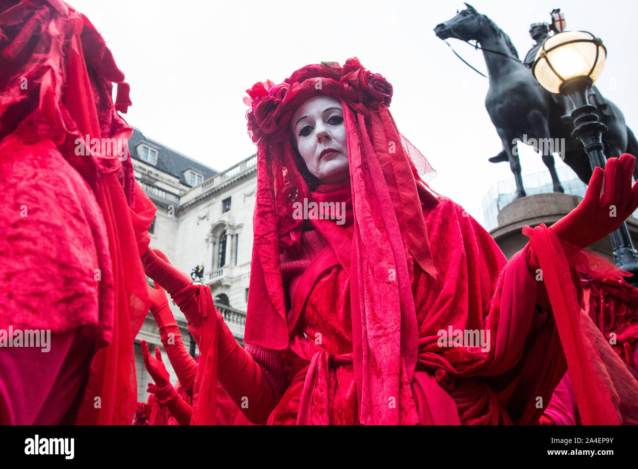 London, UK. 14 October, 2019. The Red Brigade join fellow climate activists from Extinction Rebellion staging theatrical mock trials, of the UK’s financial sector for the crime of ecocide and of the Government for ‘criminal negligence’ in having permitted it, in front of the Bank of England. Roads were blocked around Bank on the eighth day of International Rebellion protests across London. Credit: Mark Kerrison/Alamy Live News Stock Photo