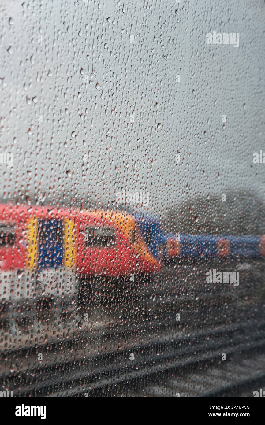 Rain droplets on suburban train window- close-up, Stock Photo