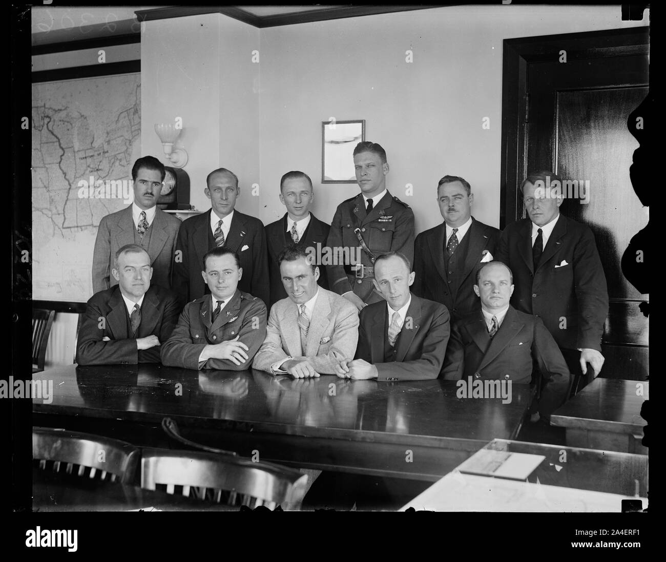 This may help the weather reports. These transoceanic flyers, meeting in Washington with officials of the U.S. Weather Bureau and the Department of Commerce. the Meteorology Committee of the Guggenheim Foundation and representatives of other aeronautical interests, hope to help in improving weather service for aviators. Left to right, seated: Assistant Secretary of Commerce for Aeronautics William P. McCracken, Jr. , Lt. A.F. Hagenberger, Col. Arthur C. Goebel, Paul Schluter, Charles Levine, left to right, standing: Emory Bronte, Edward F. Schlee, Clarence Chamberlain, Lt. Lester J. Maitland, Stock Photo