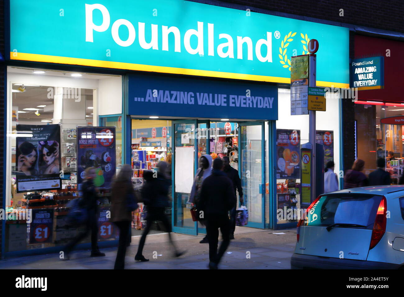 Front of the Poundland shop in Hammersmith at night-time, London, UK Stock Photo
