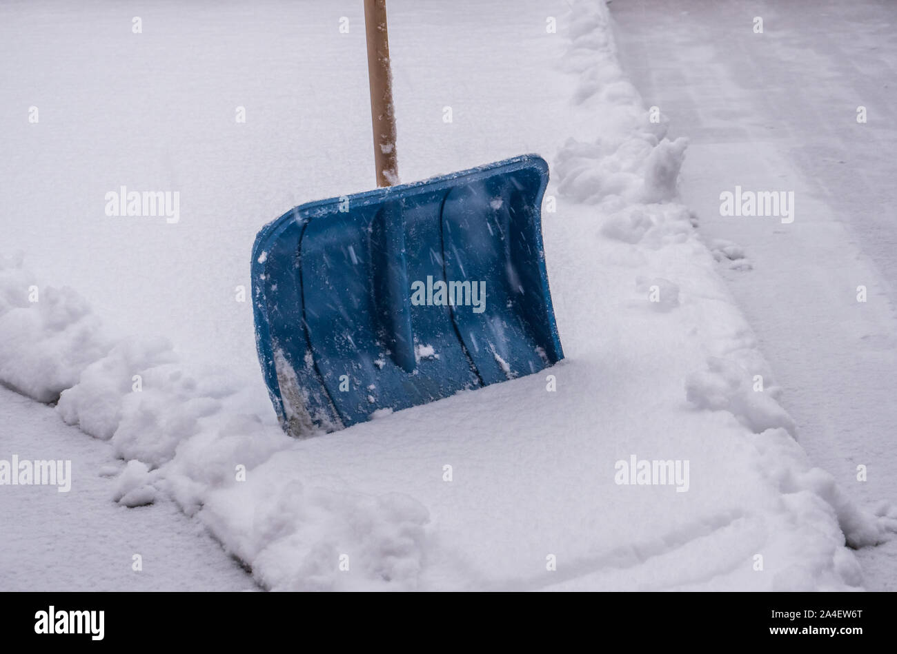Using snow shovel on a backyard Stock Photo