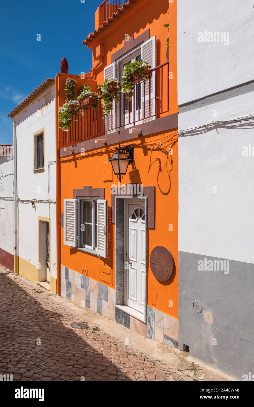Bright orange painted house in the historic town of Silves in Portugal which was once the capital of the Algarve Stock Photo