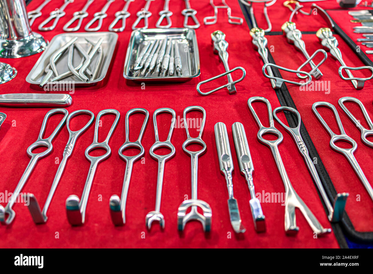 Surgical instruments and tools laid out on a red canvas. Stock Photo
