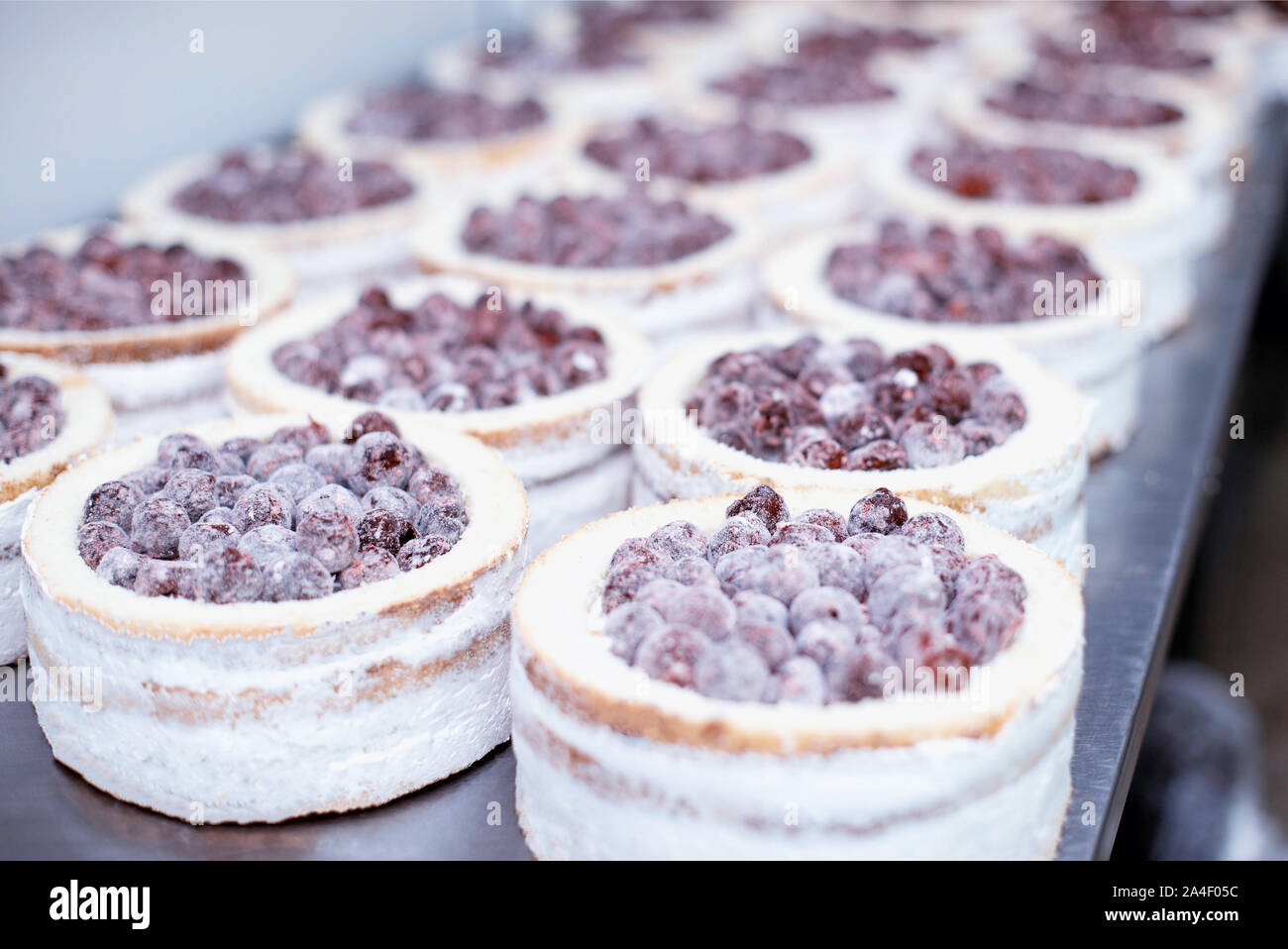 Making biscuit cakes with condensed milk in the confectionery industry with fresh cherry, food