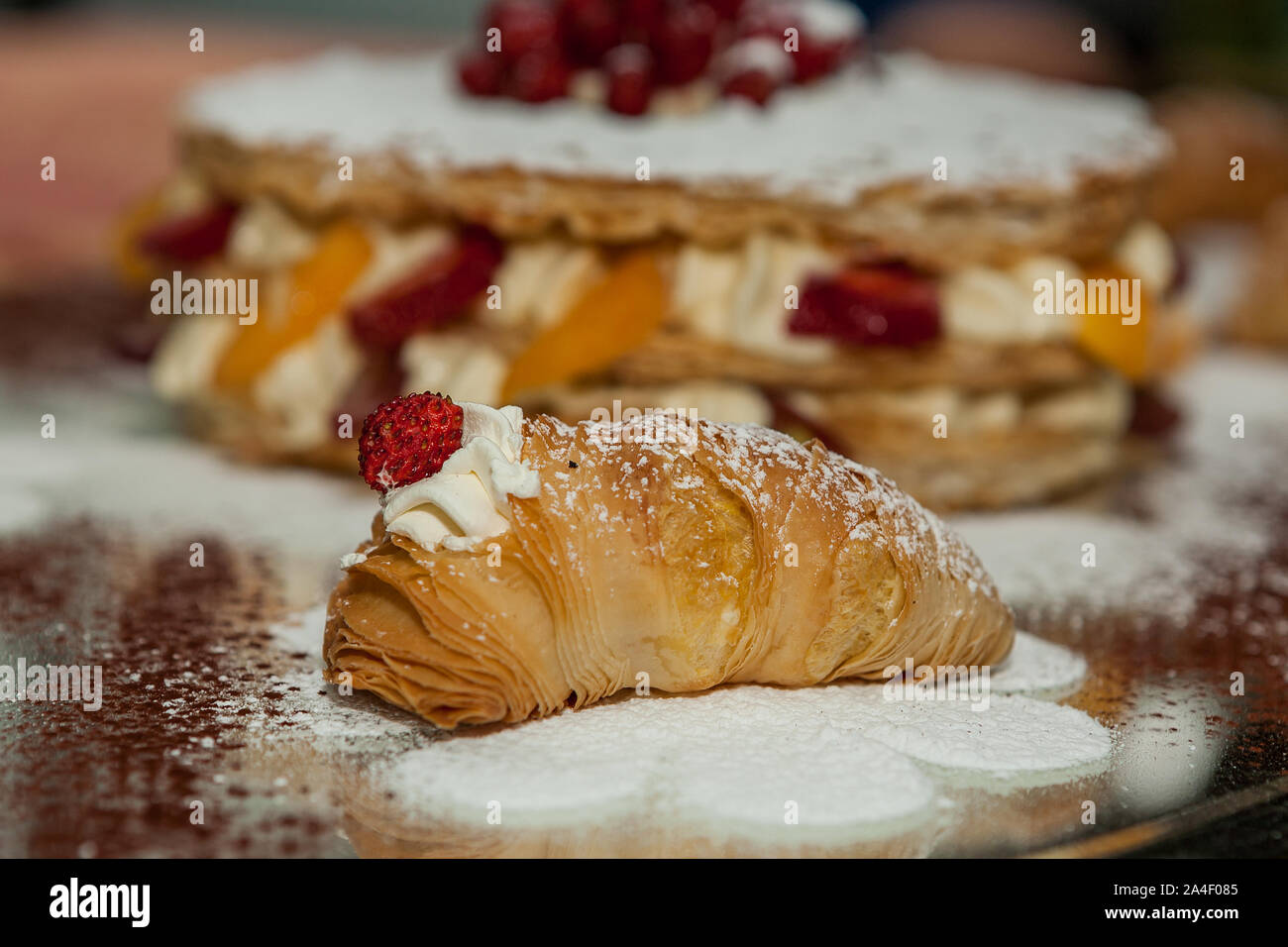 Sfogliatella, typical Neapolitan pastry, with yellow cream and strawberry, Naples, Italy. Stock Photo