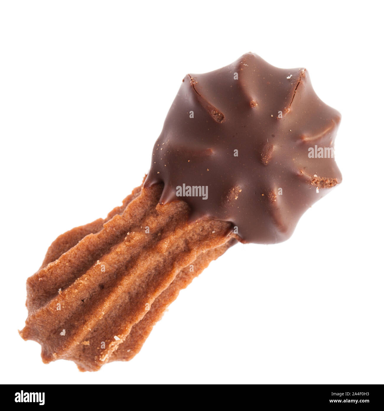 Christmas pastry:  Single dark cookie with chocolate on one end from above, isolated on white background Stock Photo
