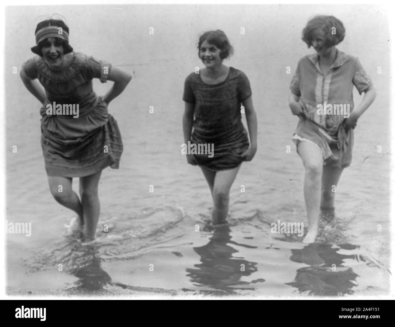 Three models from Washington's spring fashion show [wading] snapped at Arlington Beach Stock Photo