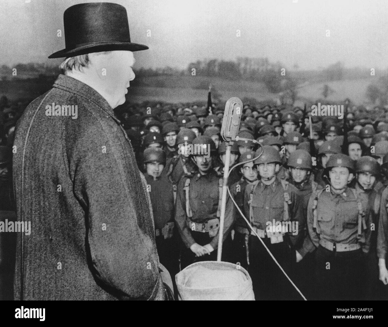 Winston Churchill addressing American troops practicing for the D-day invasion of France. March 1944 Stock Photo