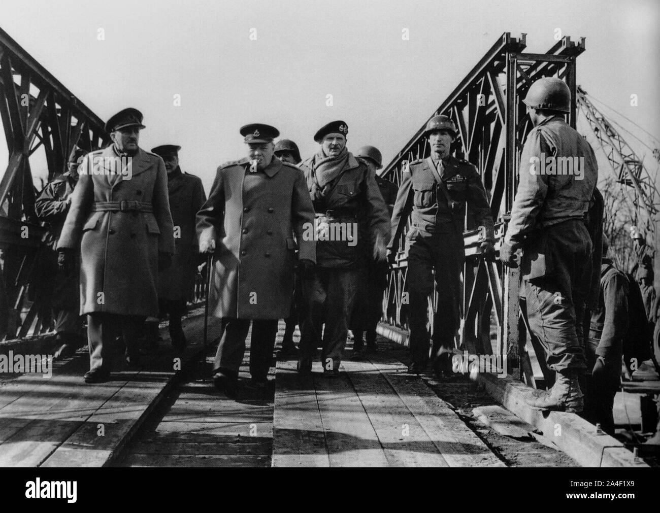 Winston Churchill with Generals Brooke, Montgomery and Simpson inspect a bridge recently captured from the Germans by the U.S. 9th Army. March 1945 Stock Photo