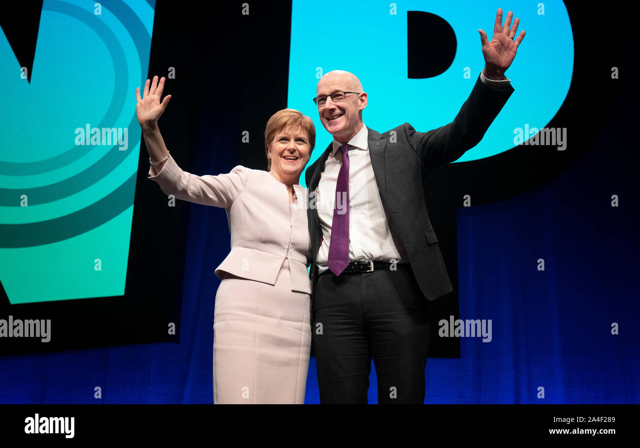 Deputy First Minister John Swinney, on stage with First Minister Nicola Sturgeon, after delivering his address to delegates during the 2019 SNP autumn conference at the Event Complex in Aberdeen. Stock Photo