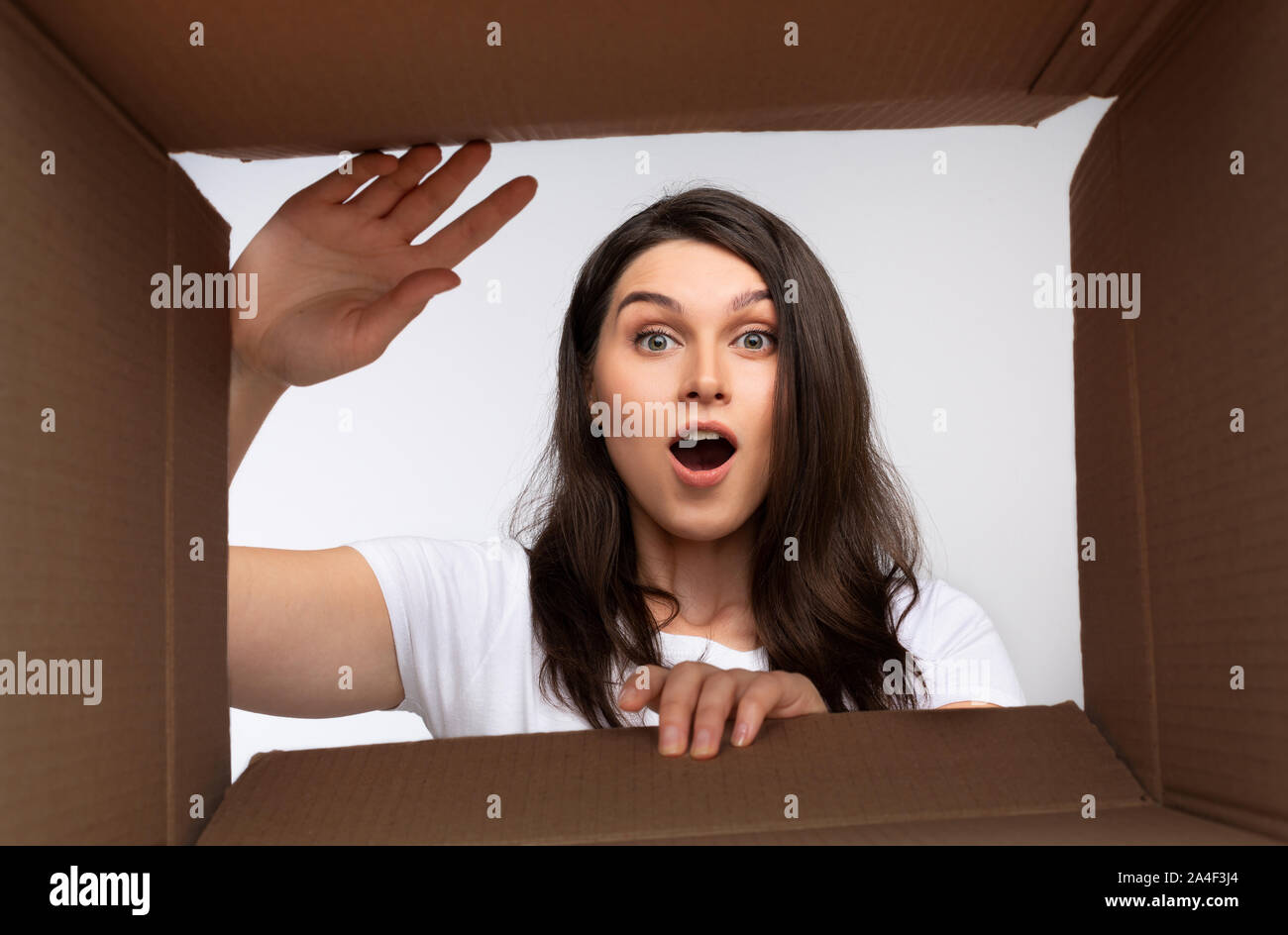 Excited Lady Looking Into Empty Box, Bottom View Stock Photo