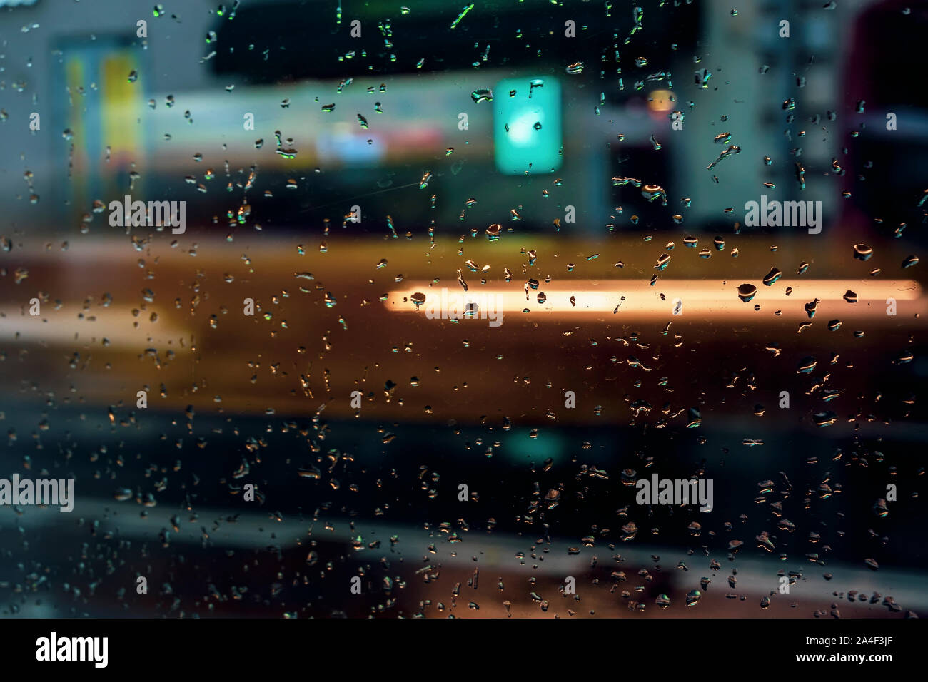 Real life rain drops scene taken from inside car windshield traffic lights  background Stock Photo - Alamy