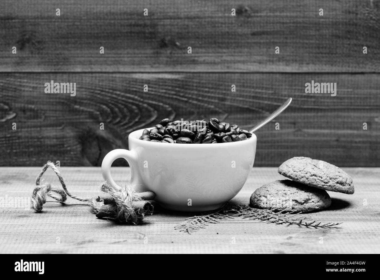Cup full coffee brown roasted bean blue wooden background. Caffeine