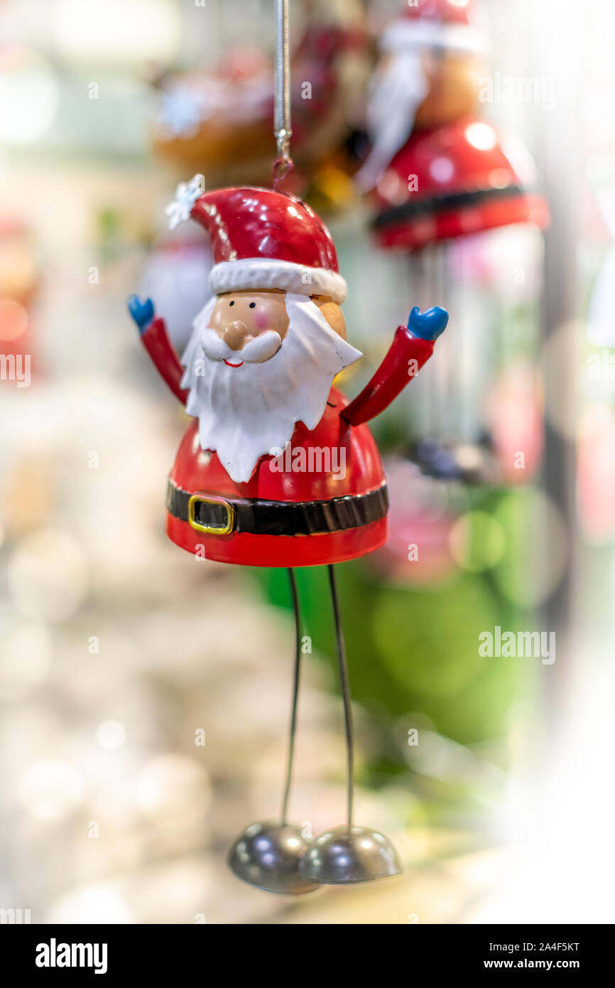 A Father Christmas tree decoration dangles from a Christmas tree in a department store. Stock Photo