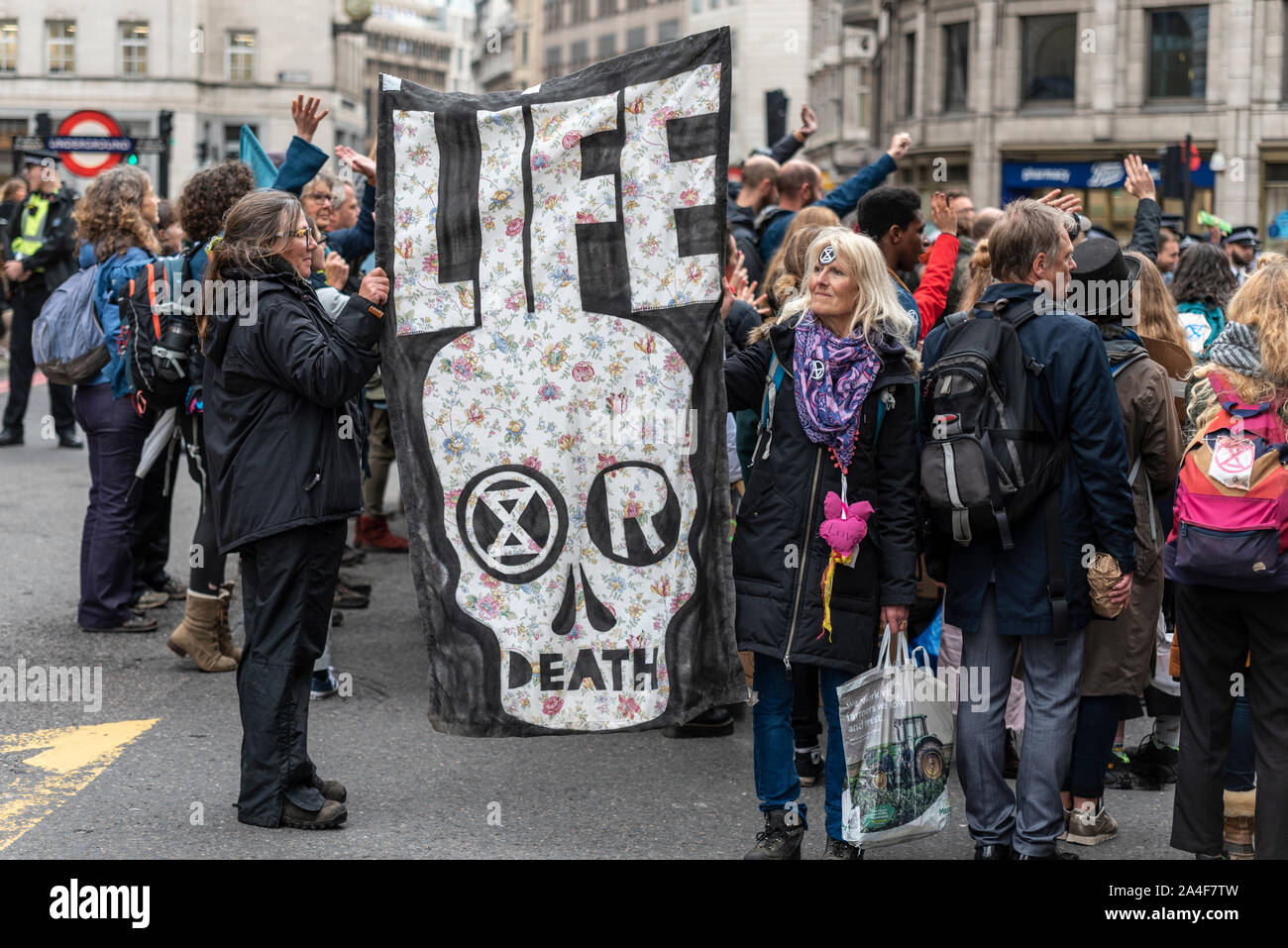 Extinction Rebellion climate protesters have continued their demonstration against their belief of Government's inaction over ecological issues despite declaring a climate emergency by blocking one end of London Bridge. Some protesters were forcefully removed by police to allow some traffic to pass Stock Photo