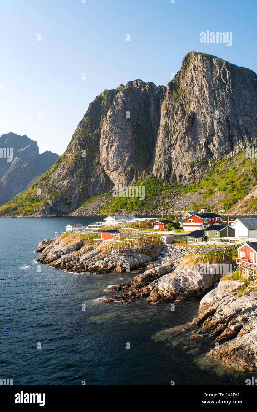 The old fishing village of Hamnoy where the rorbu (fishermen’s huts) are now used for tourist accommodation backed by Festhelltinden Mountain.  Lofote Stock Photo